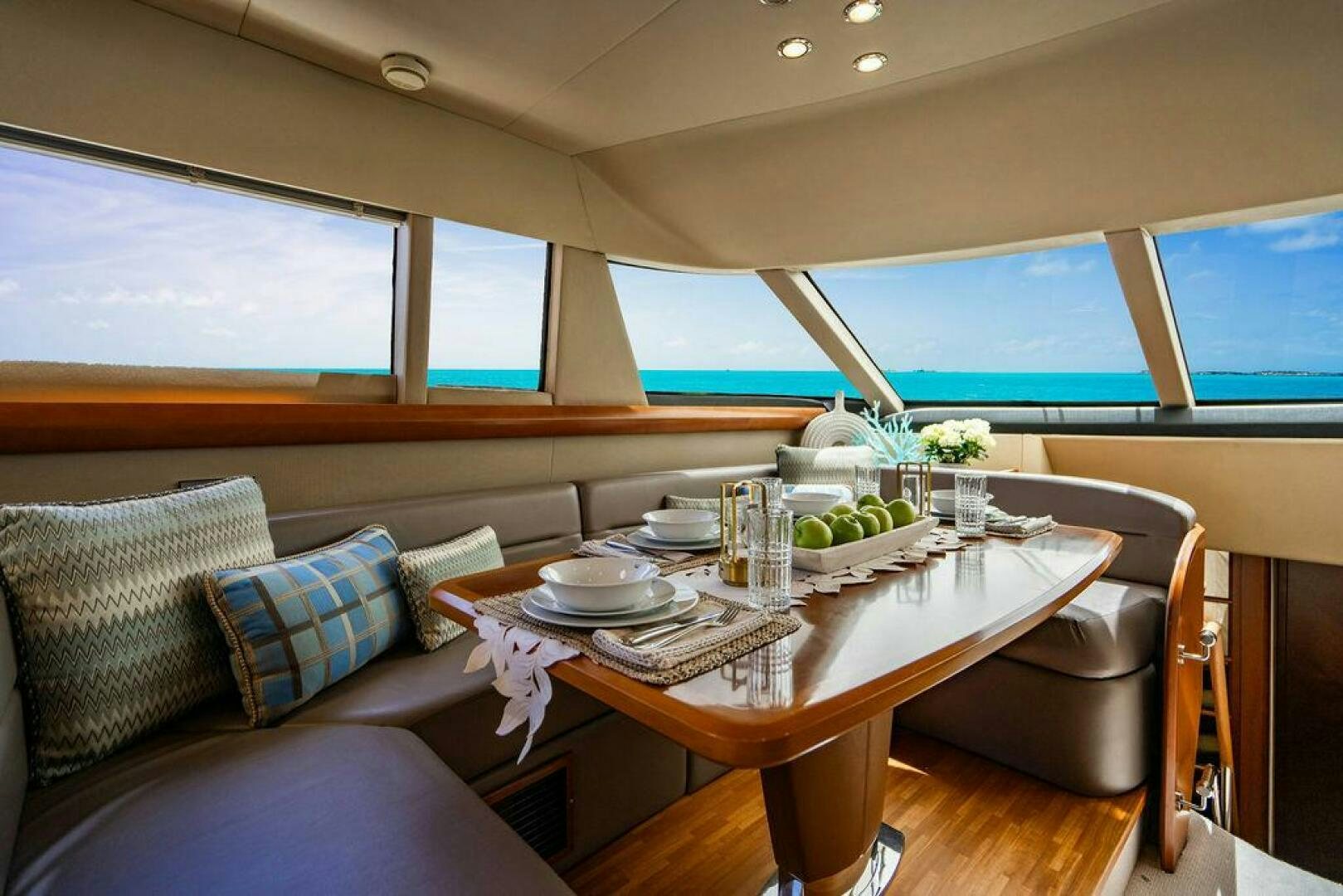 a table with plates and cups on it aboard EMPIRE SUN Yacht for Sale
