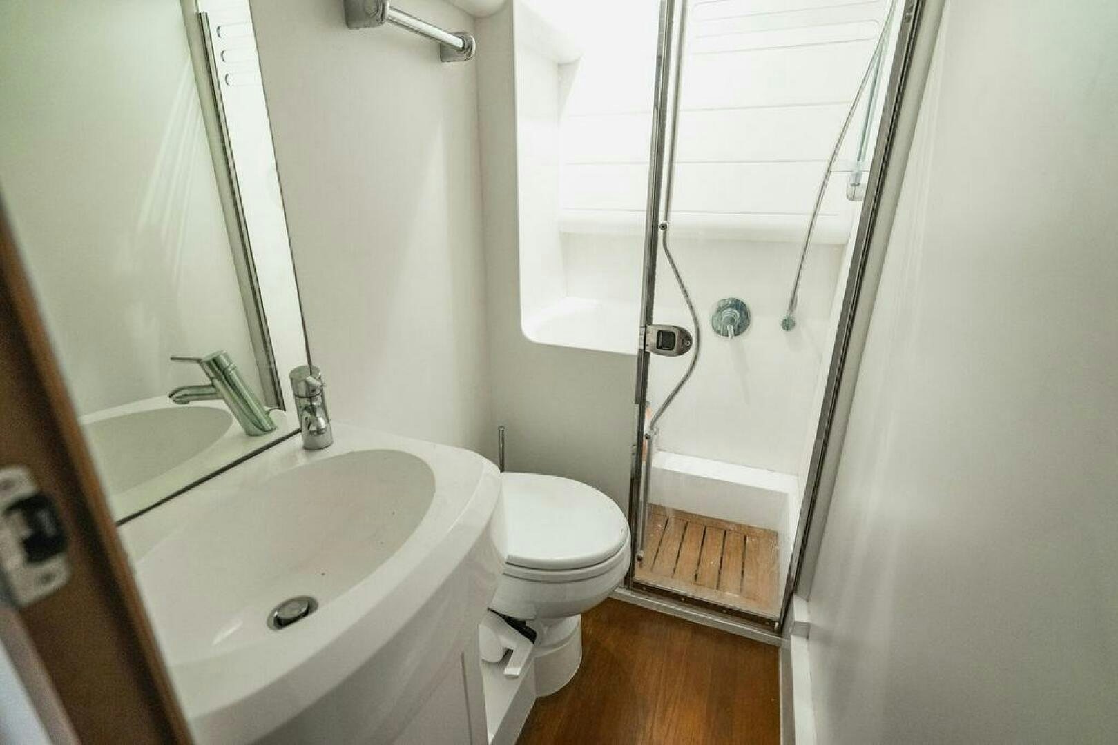 a bathroom with a sink toilet and shower aboard EMPIRE SUN Yacht for Sale