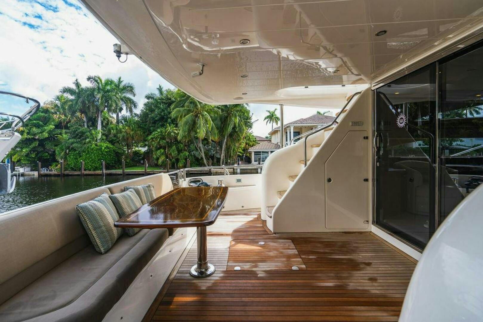 a deck with a table and chairs aboard EMPIRE SUN Yacht for Sale
