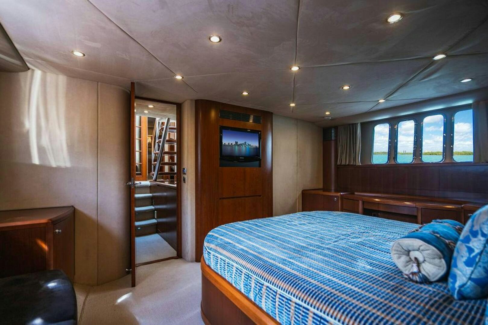 a bedroom with a bed and a television aboard EMPIRE SUN Yacht for Sale