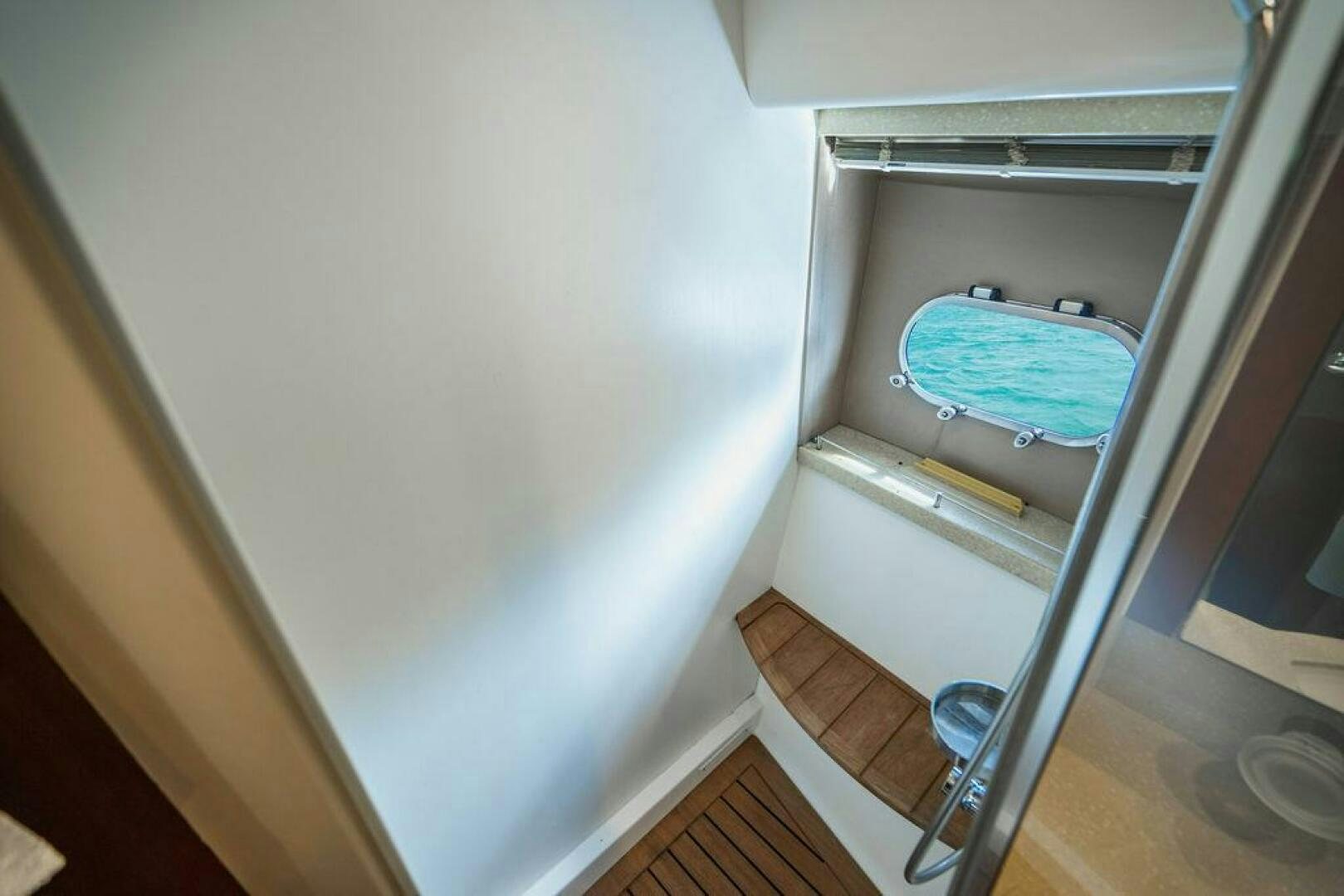 a white toilet with a blue seat aboard EMPIRE SUN Yacht for Sale