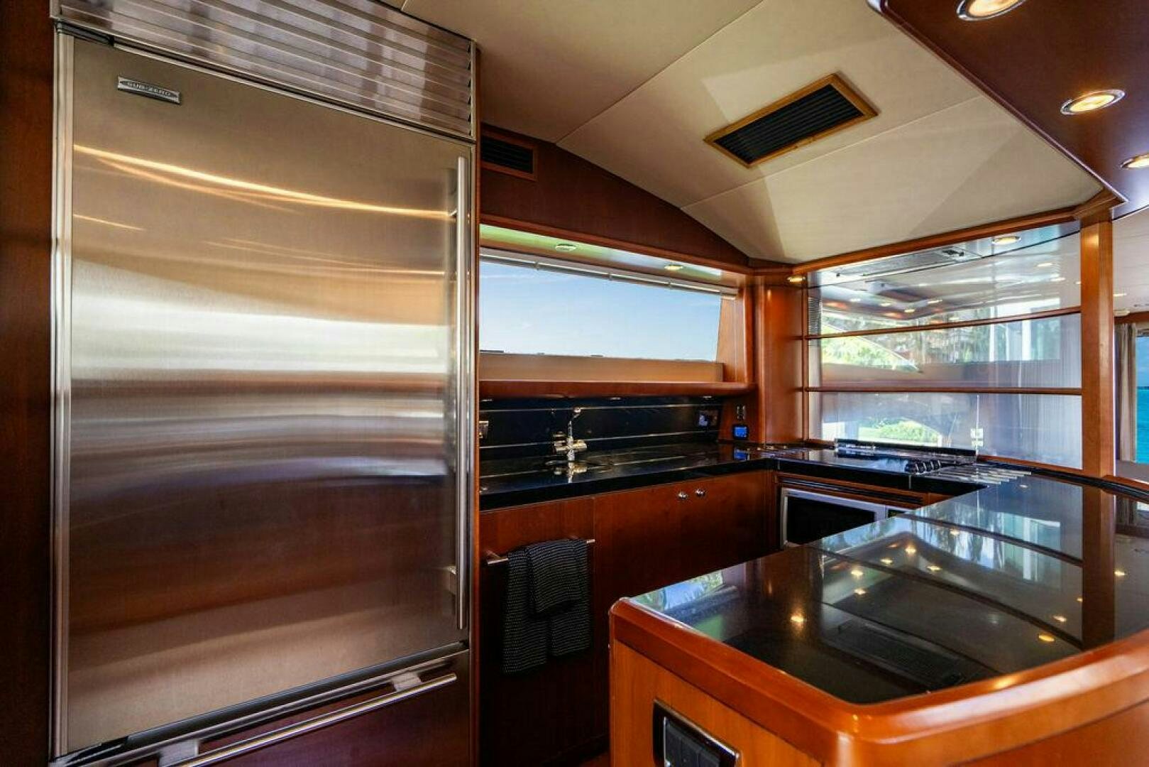 a kitchen with a large refrigerator aboard EMPIRE SUN Yacht for Sale