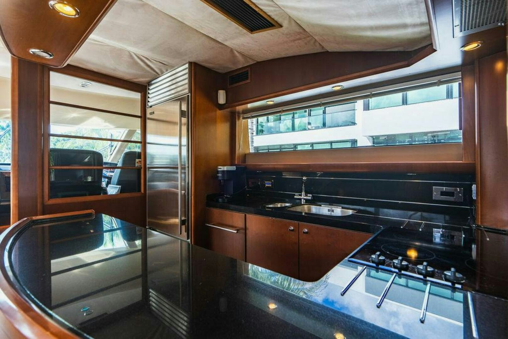 a kitchen with a large glass door aboard EMPIRE SUN Yacht for Sale