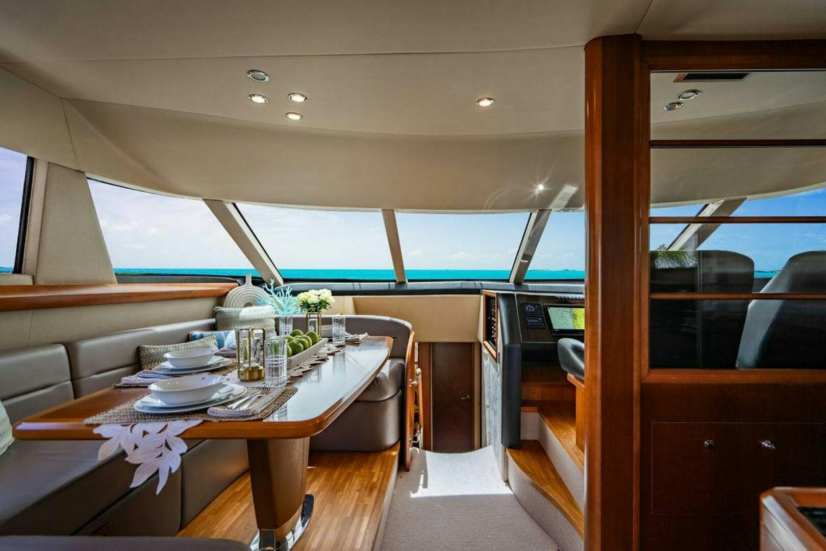 a table with plates and cups on it aboard EMPIRE SUN Yacht for Sale