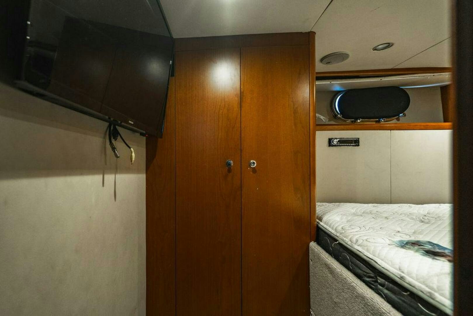 a room with a bed and a television aboard EMPIRE SUN Yacht for Sale