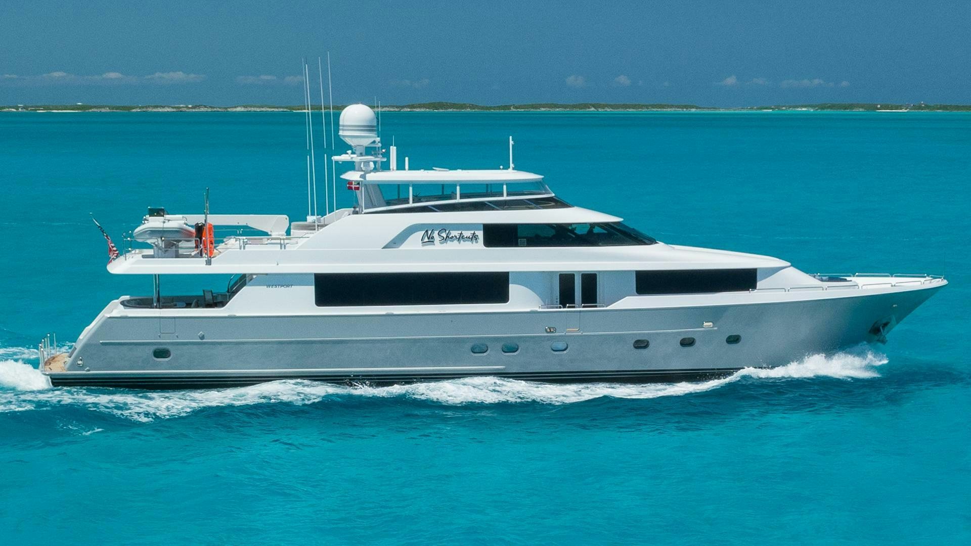 a white yacht in the water aboard NO SHORTCUTS Yacht for Sale