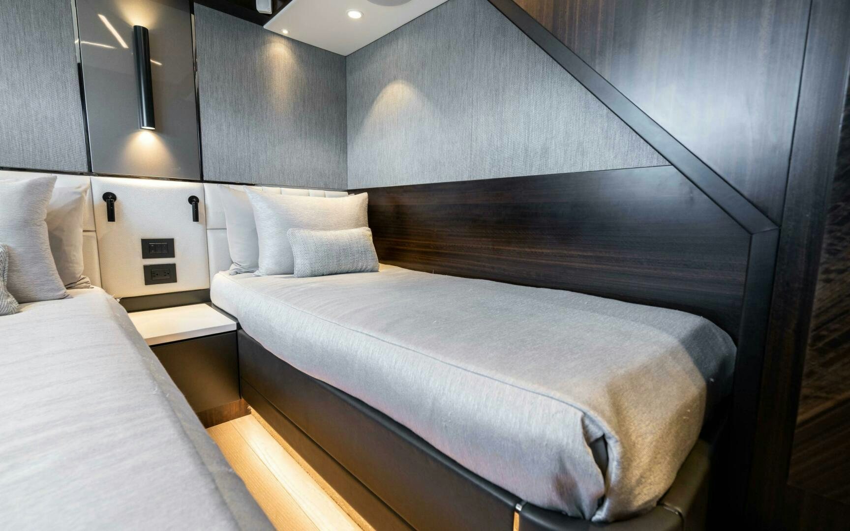a bed with a black headboard aboard 4-PLAY VII Yacht for Sale