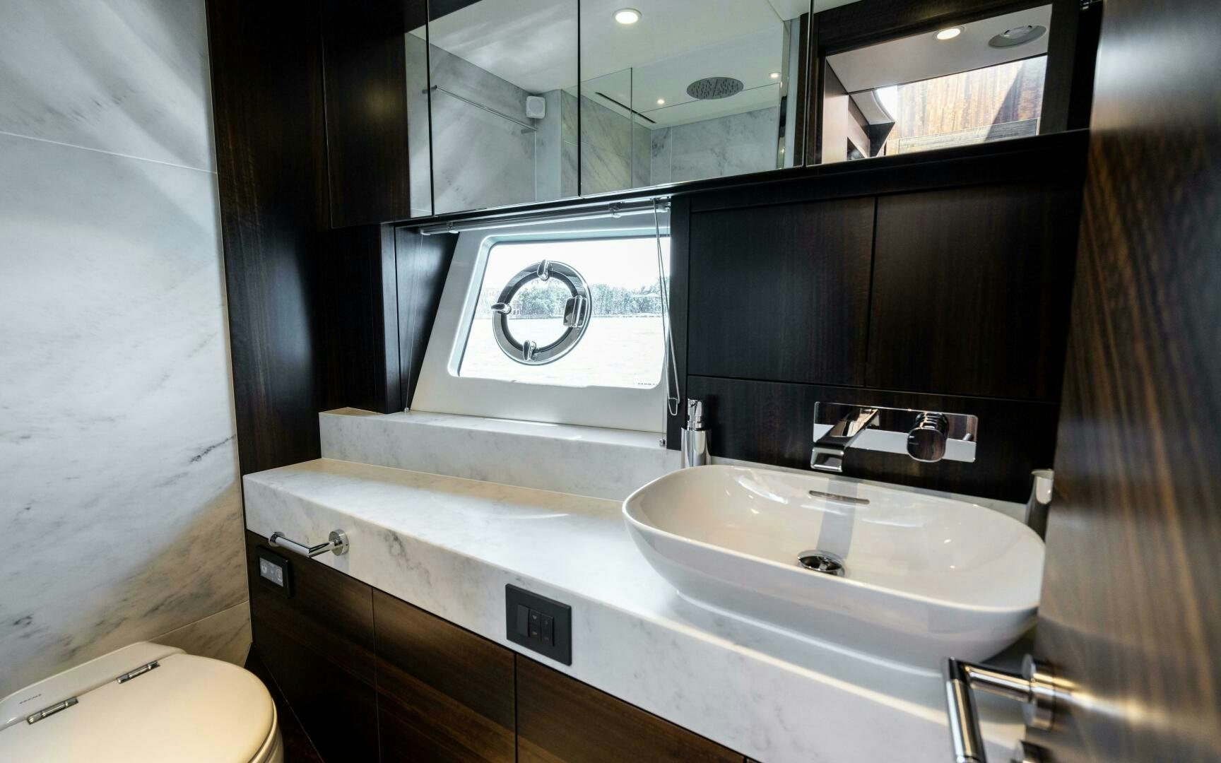 a bathroom with a sink and a mirror aboard 4-PLAY VII Yacht for Sale