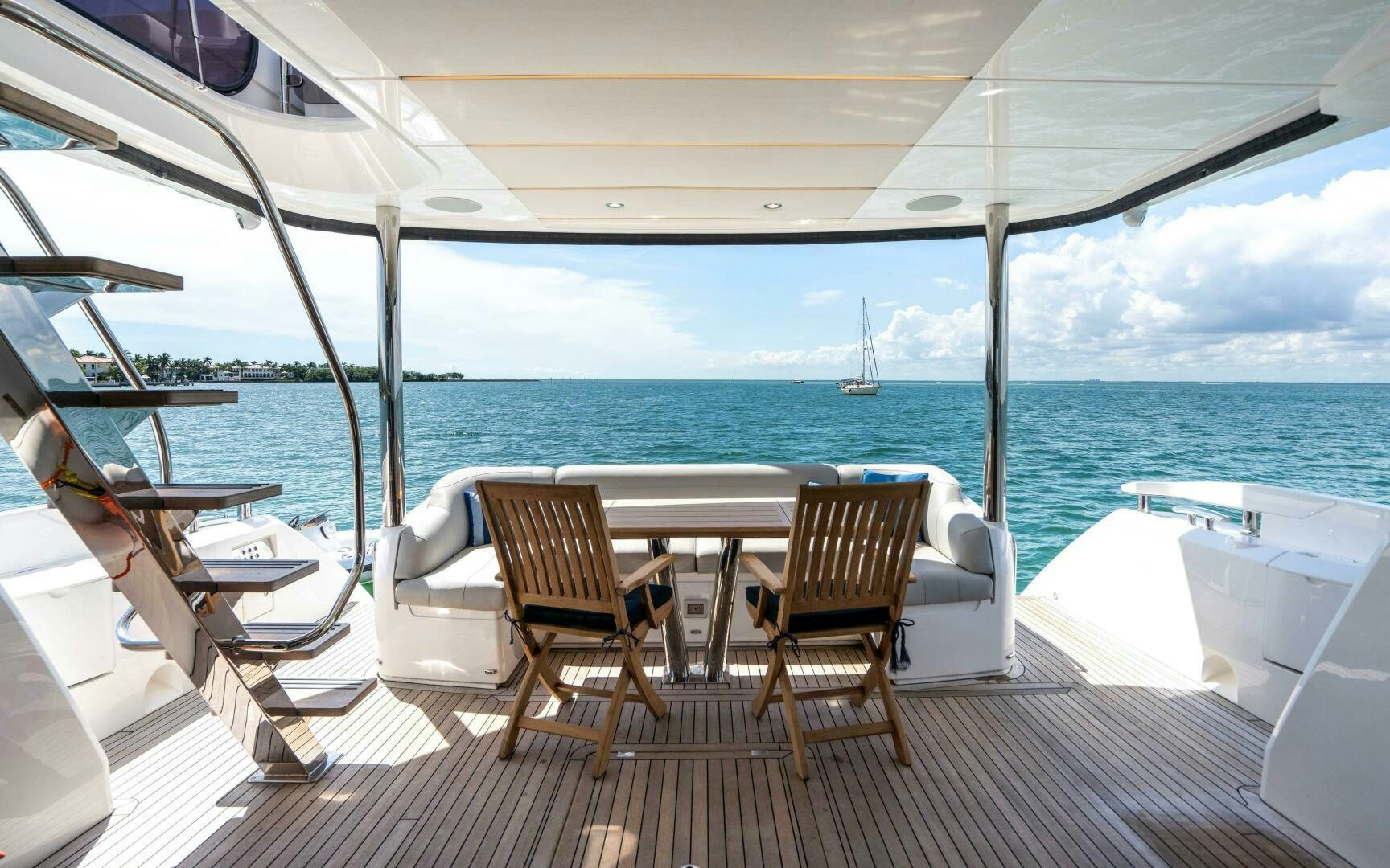 a deck with chairs and tables on it by the water aboard 4-PLAY VII Yacht for Sale