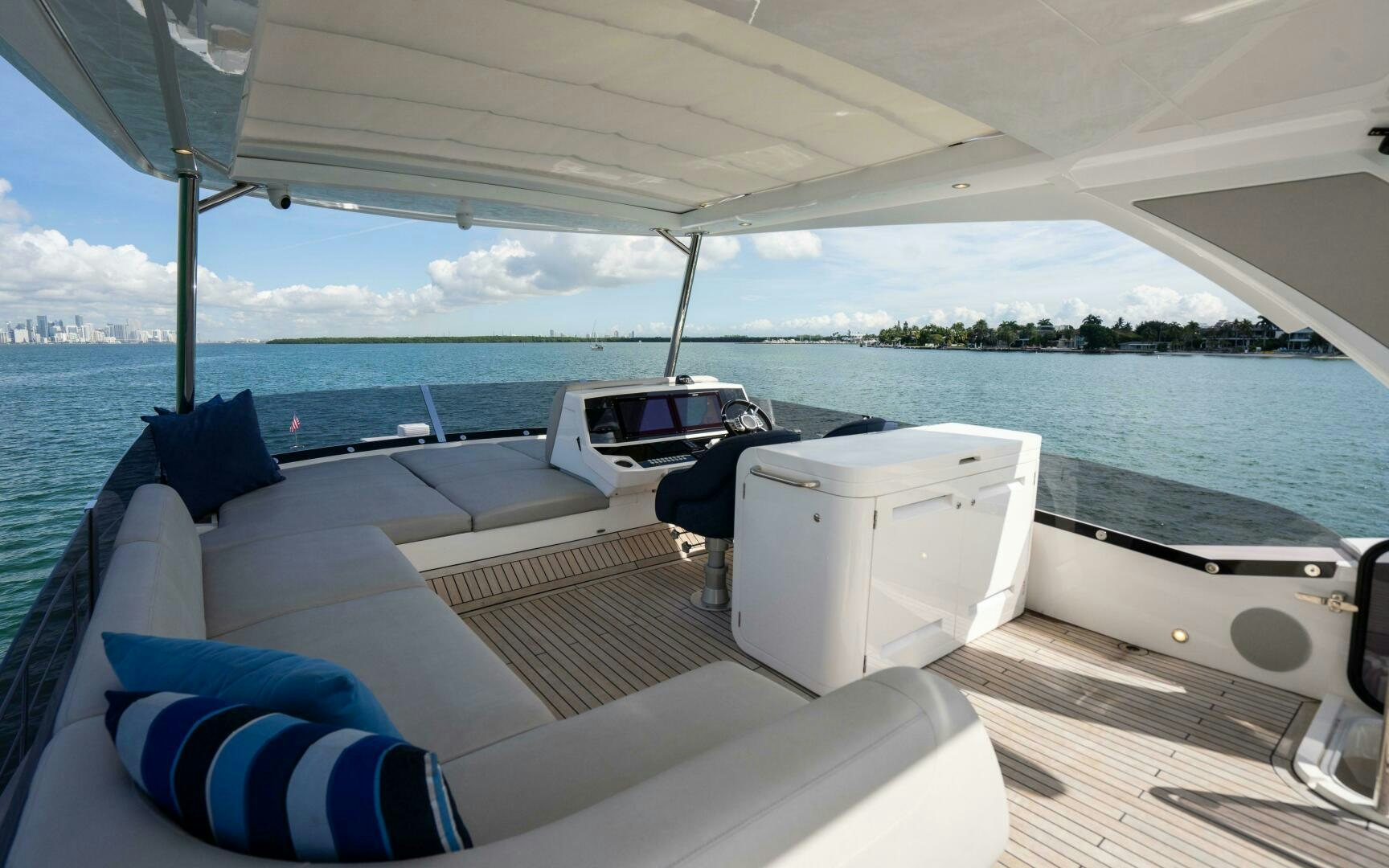 a boat with a white cover and a blue and white striped pillow on a deck with a blue aboard 4-PLAY VII Yacht for Sale