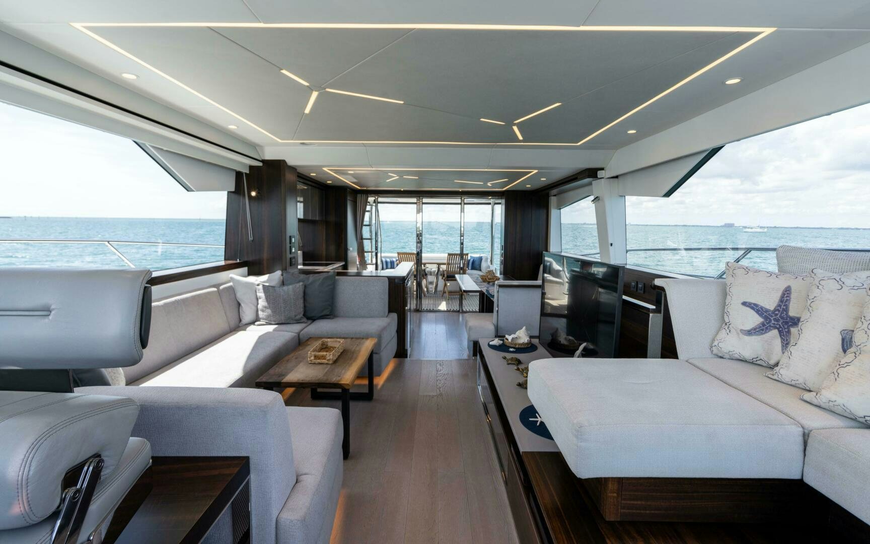 a living room with a couch and a table aboard 4-PLAY VII Yacht for Sale