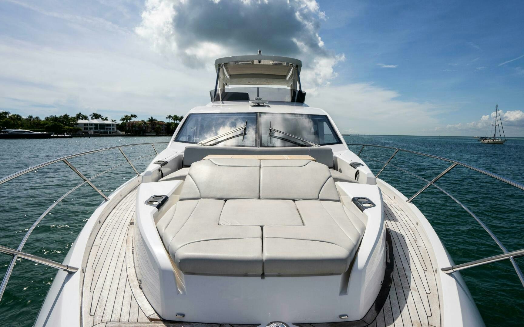 a white boat on a body of water aboard 4-PLAY VII Yacht for Sale