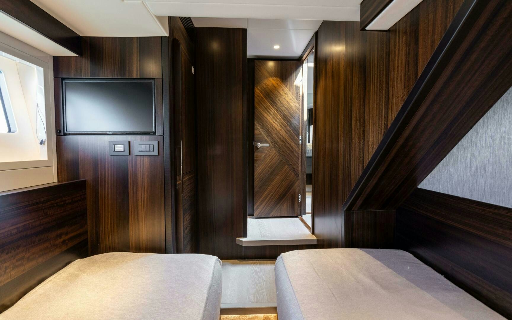 a room with a bed and a tv aboard 4-PLAY VII Yacht for Sale