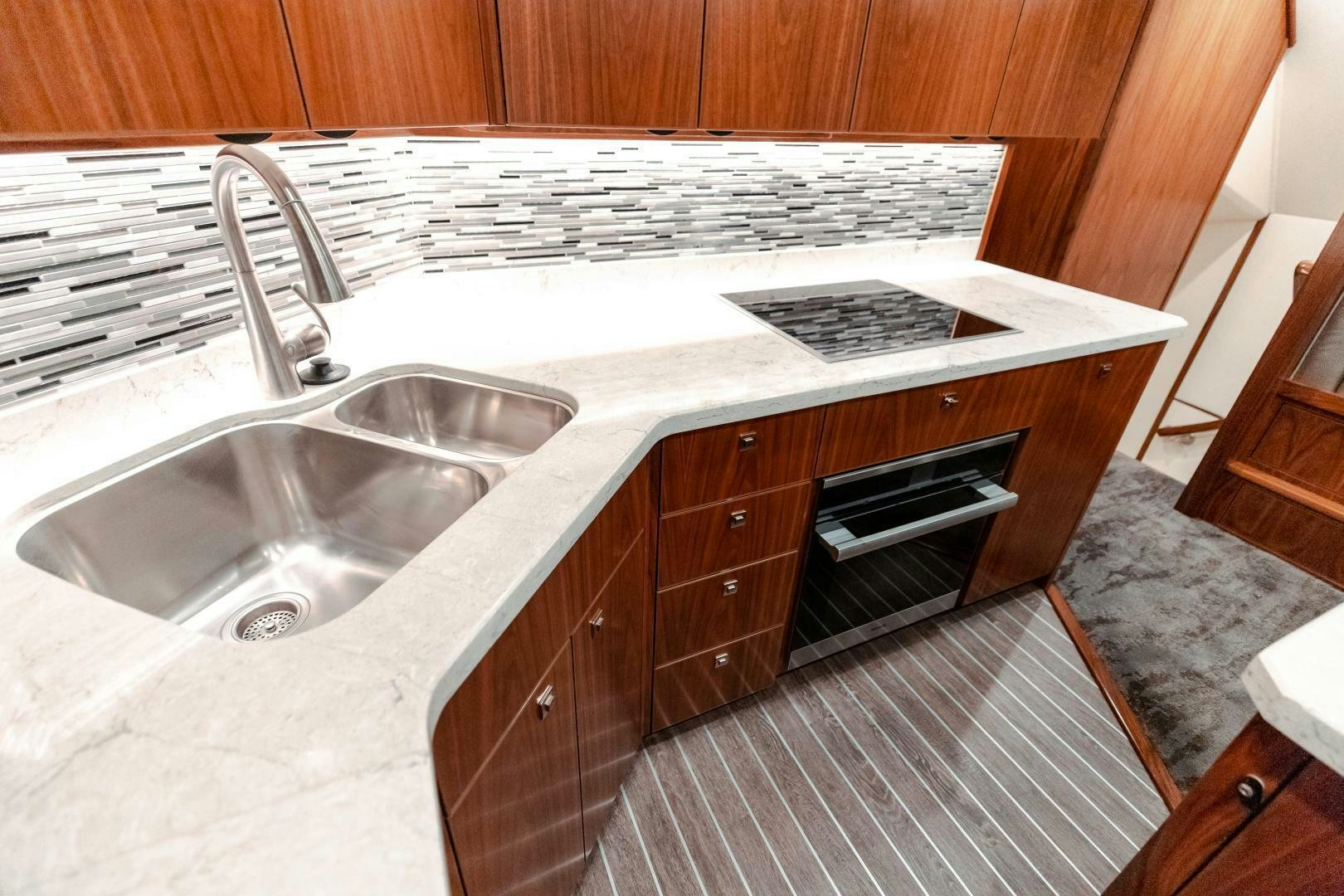 a kitchen with a sink and oven aboard AEI Yacht for Sale
