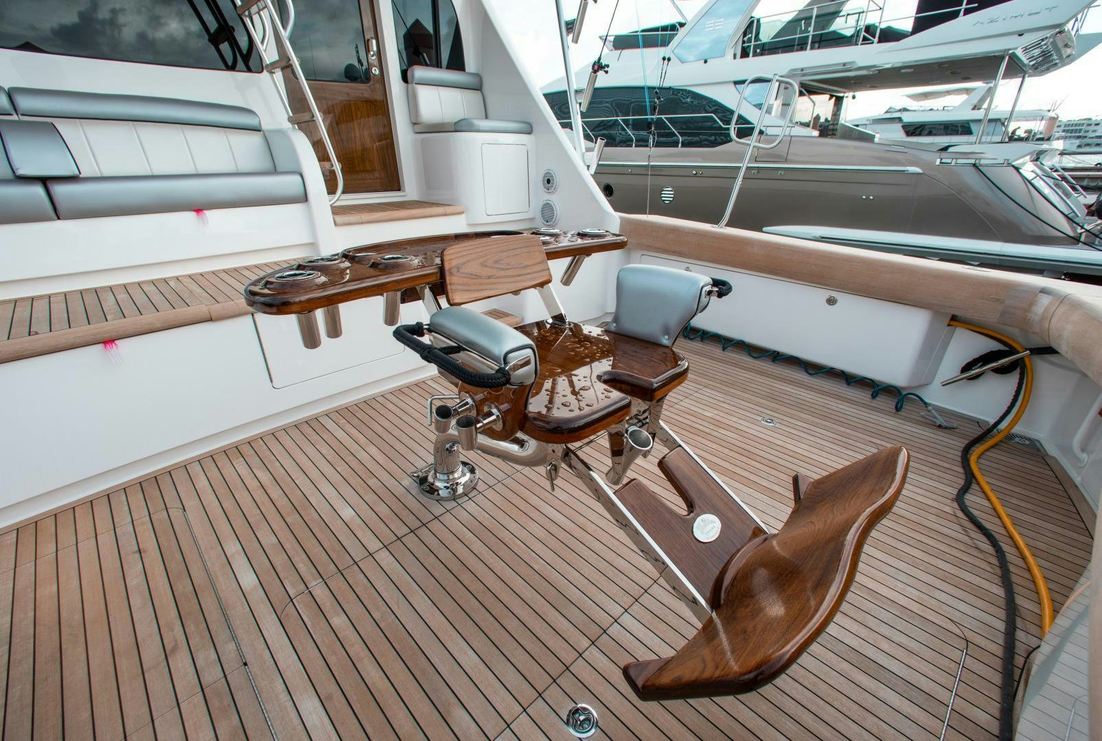 a wooden boat with a chair aboard AEI Yacht for Sale
