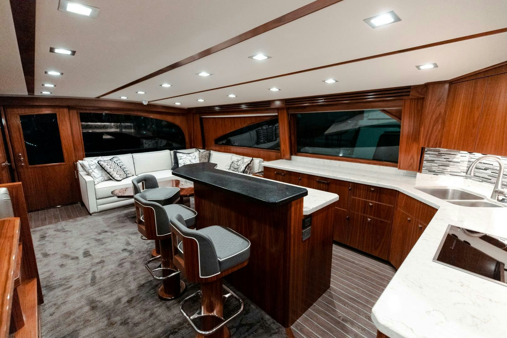 a kitchen with a bar and a bar and a table aboard AEI Yacht for Sale