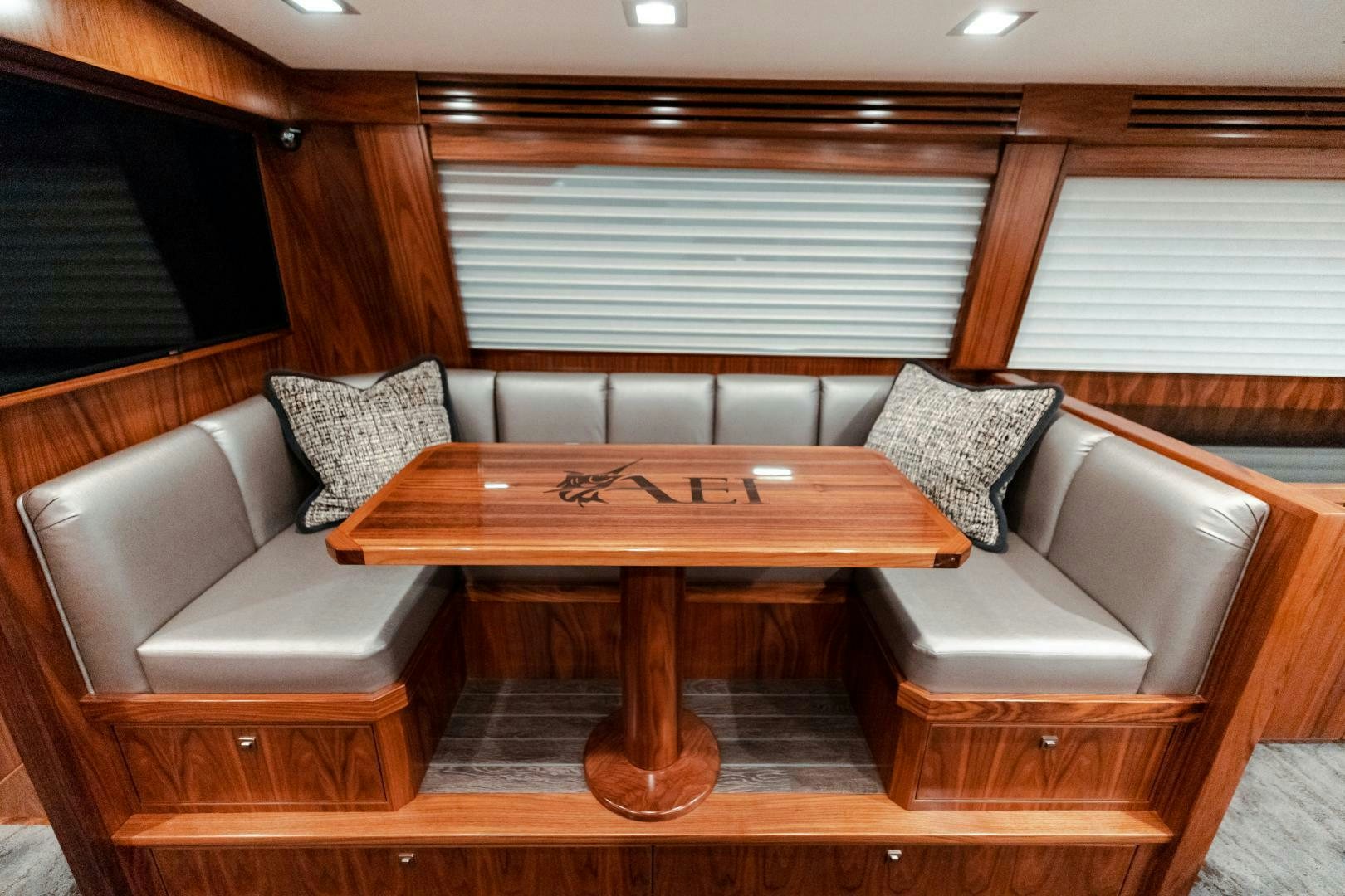 a table and chairs in a room aboard AEI Yacht for Sale