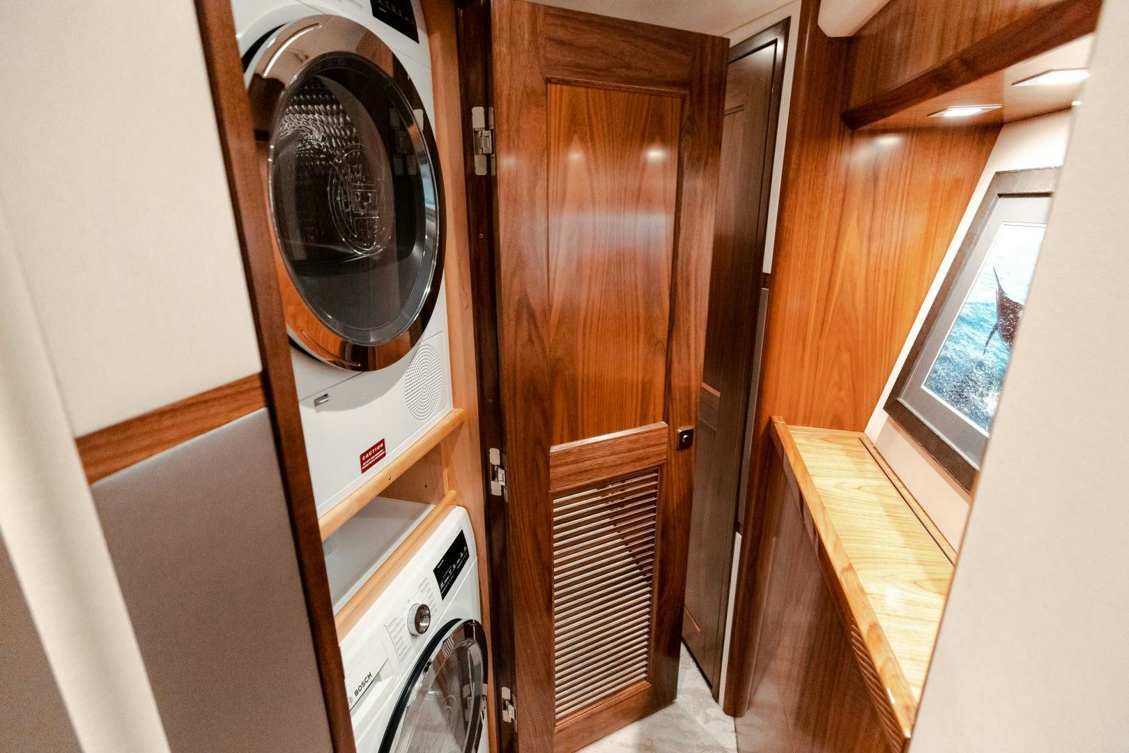 a washer and dryer in a room aboard AEI Yacht for Sale
