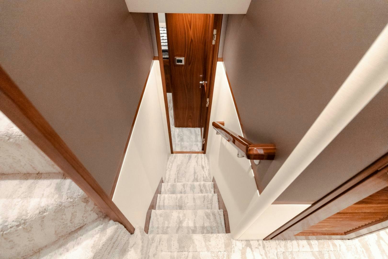 a hallway with a wood door aboard AEI Yacht for Sale