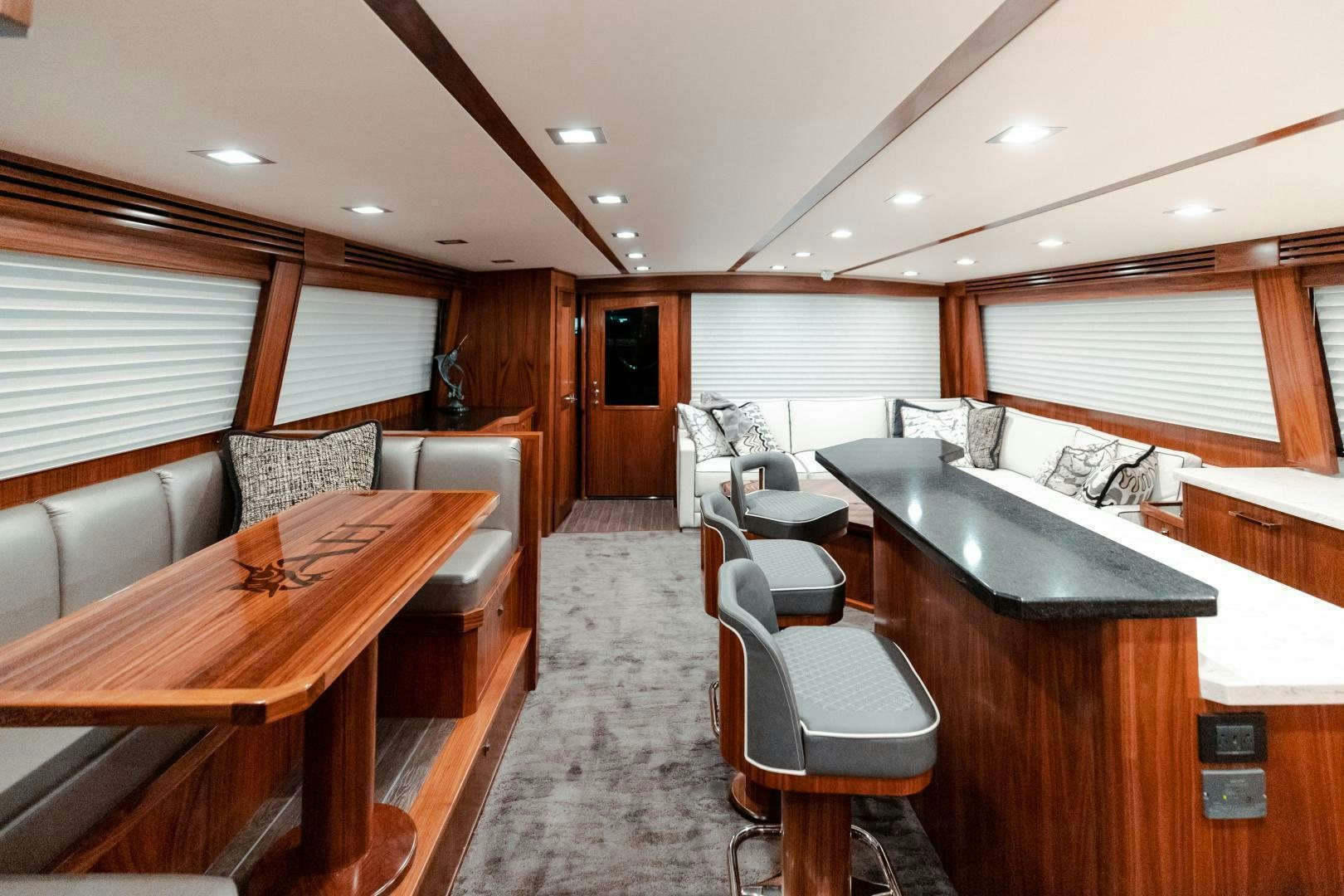 a large room with a table and chairs aboard AEI Yacht for Sale