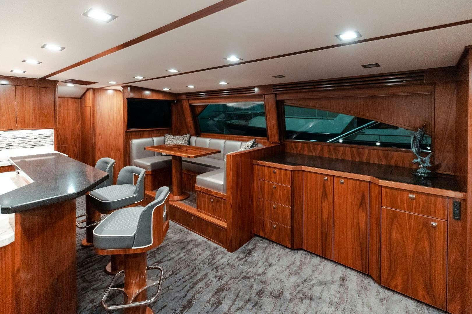 a room with a table and chairs aboard AEI Yacht for Sale