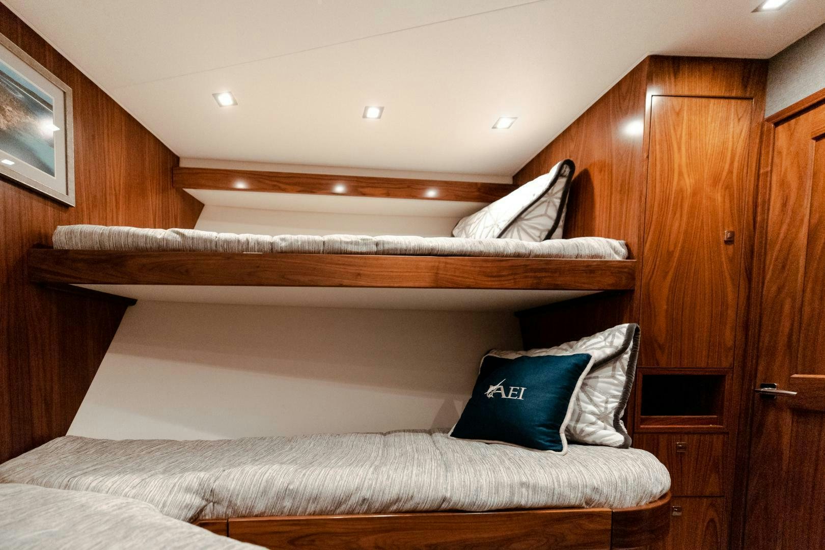 a bed with a wooden headboard aboard AEI Yacht for Sale