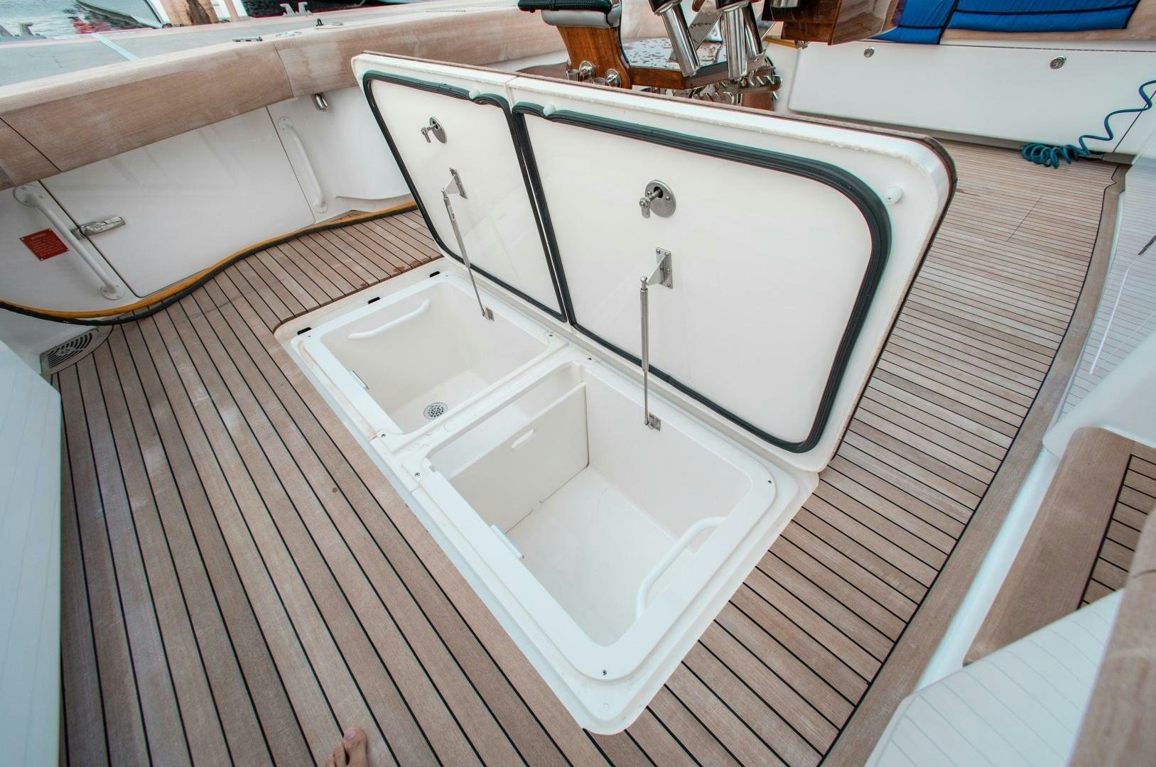 a white rectangular object on a wooden surface aboard AEI Yacht for Sale