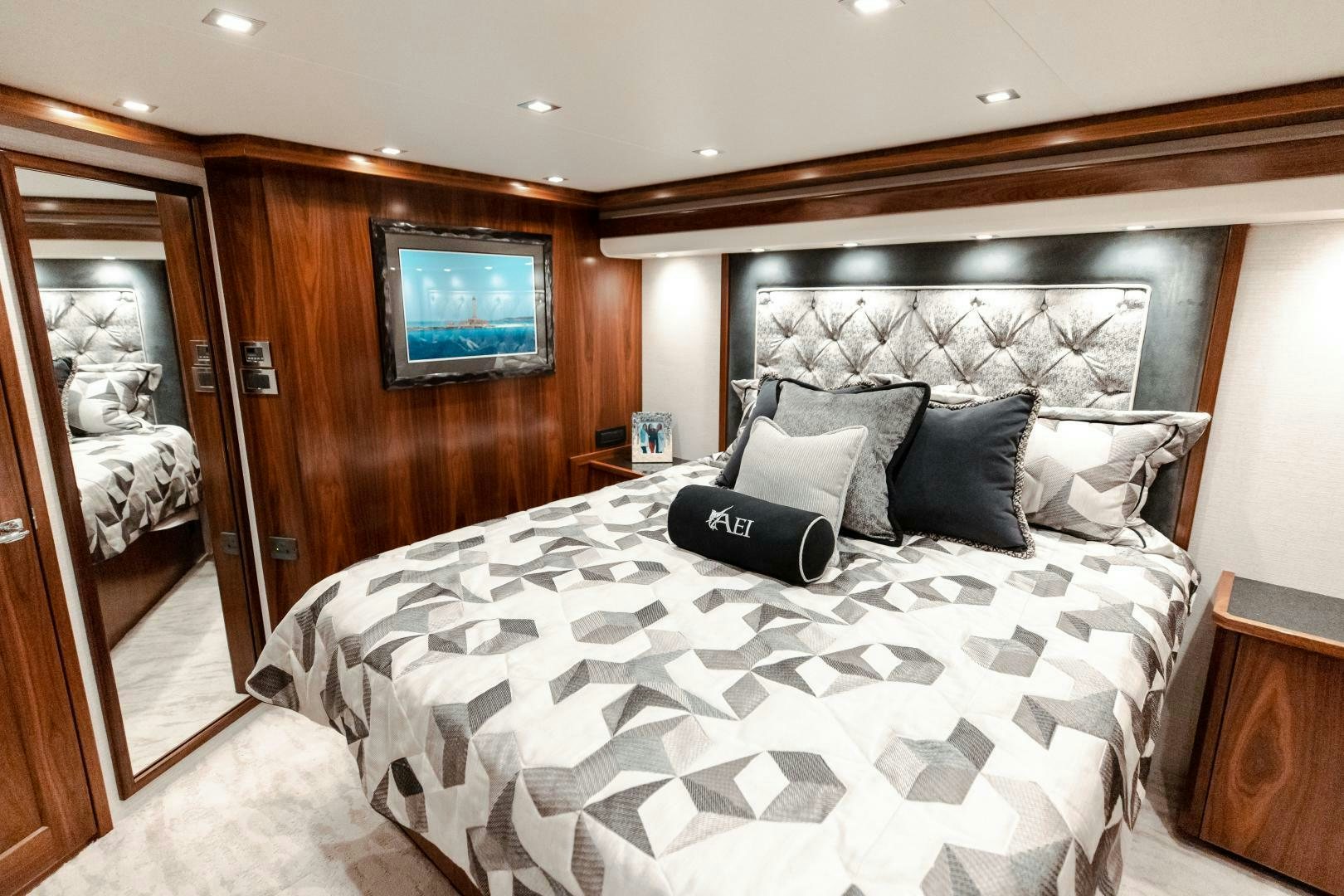 a bed with a white comforter aboard AEI Yacht for Sale