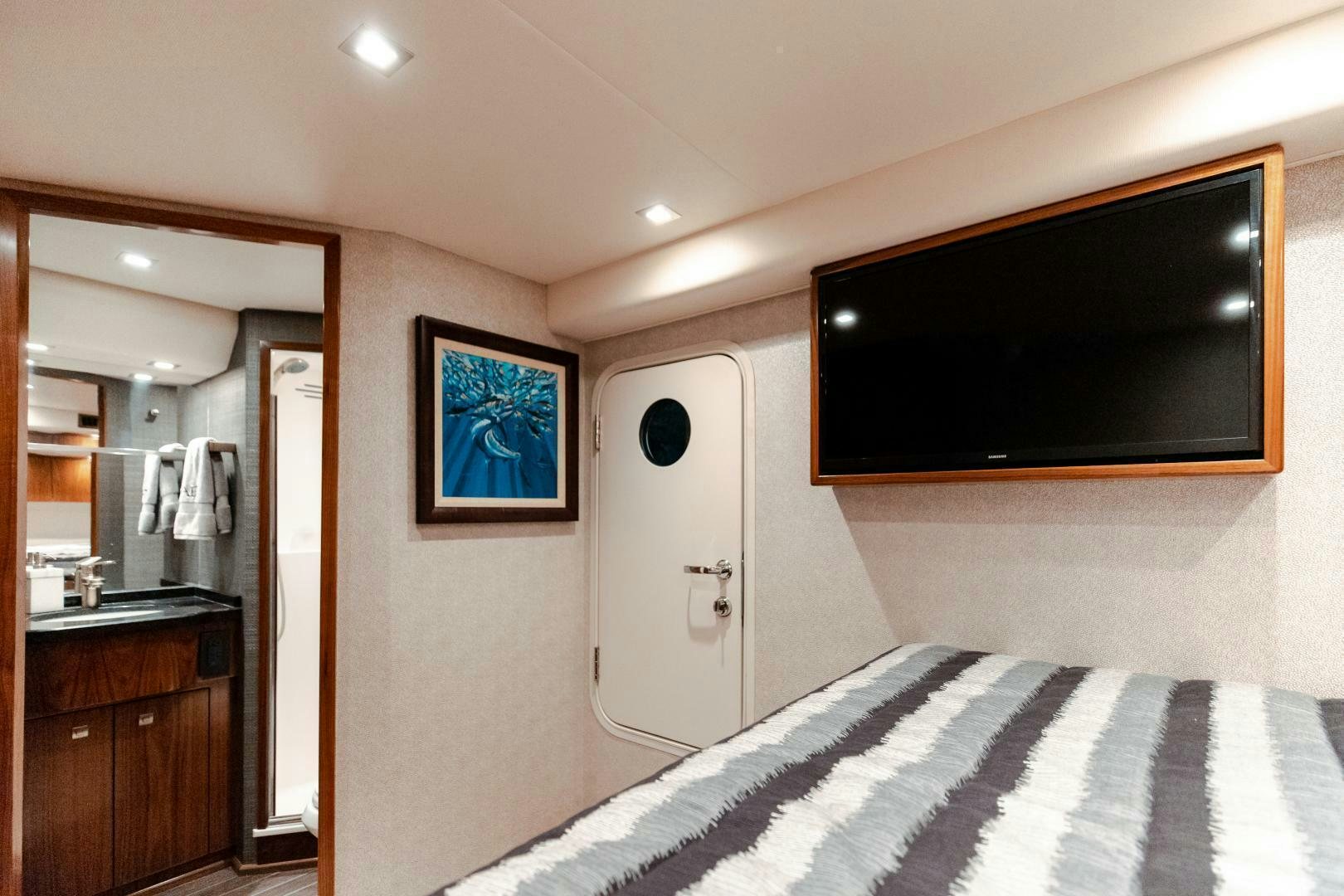 a bedroom with a tv on the wall aboard AEI Yacht for Sale