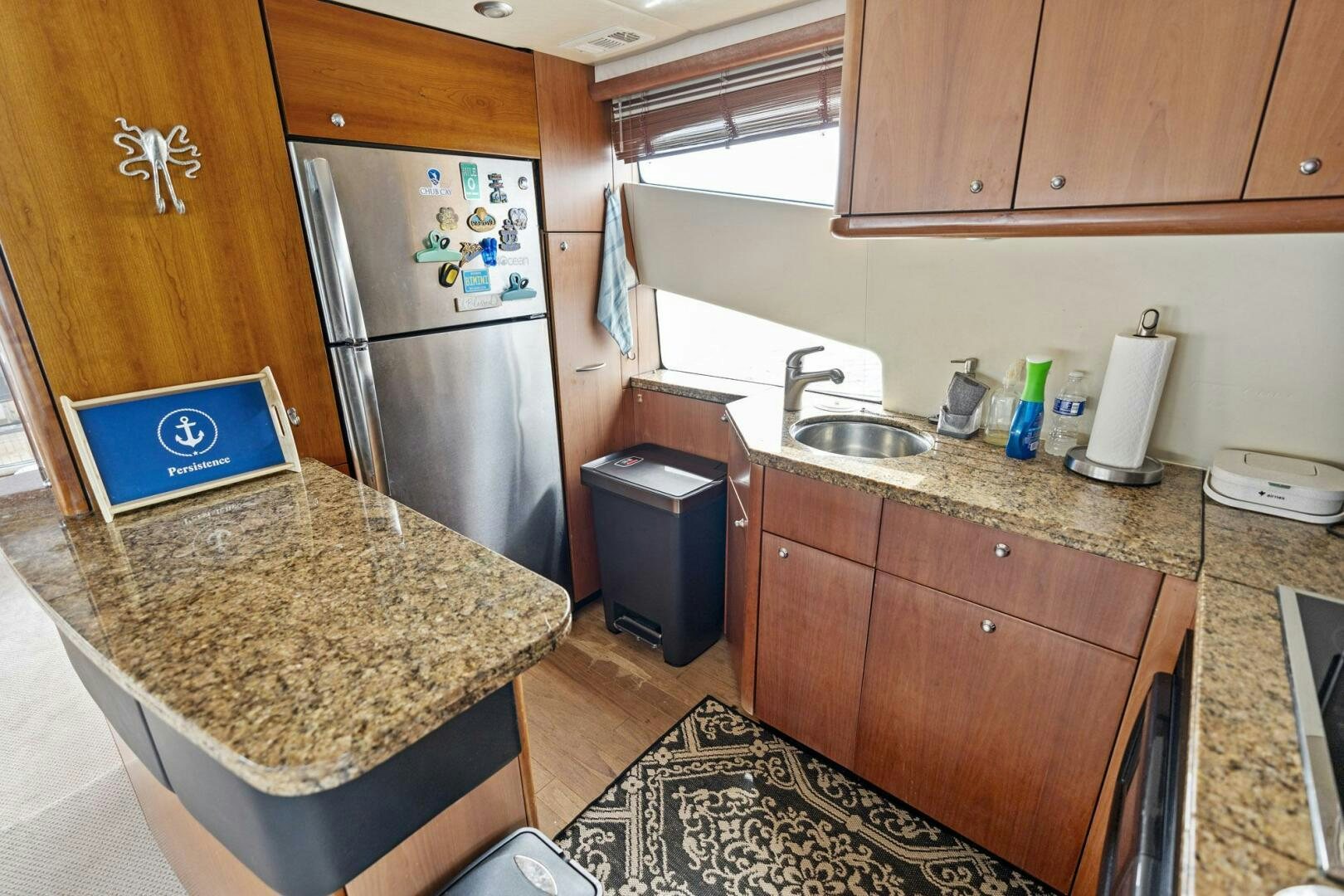 a kitchen with a laptop on the counter aboard PERSISTENCE Yacht for Sale