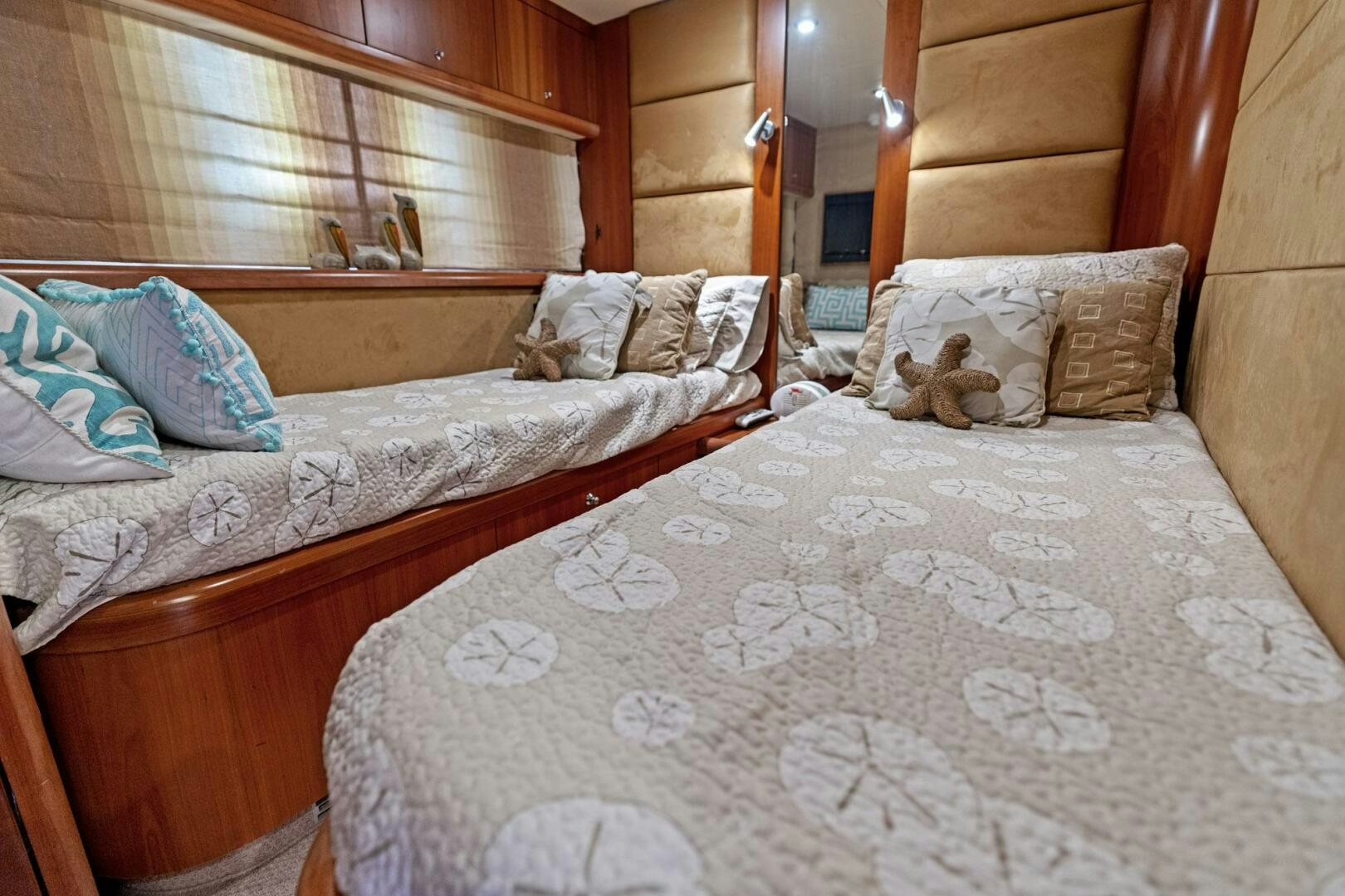 a bed with a teddy bear on it aboard PERSISTENCE Yacht for Sale