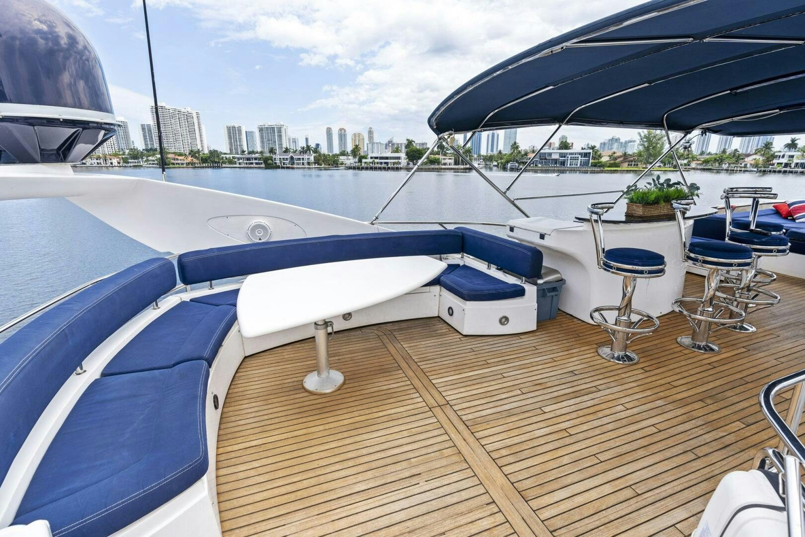a deck with a table and chairs on it aboard PERSISTENCE Yacht for Sale