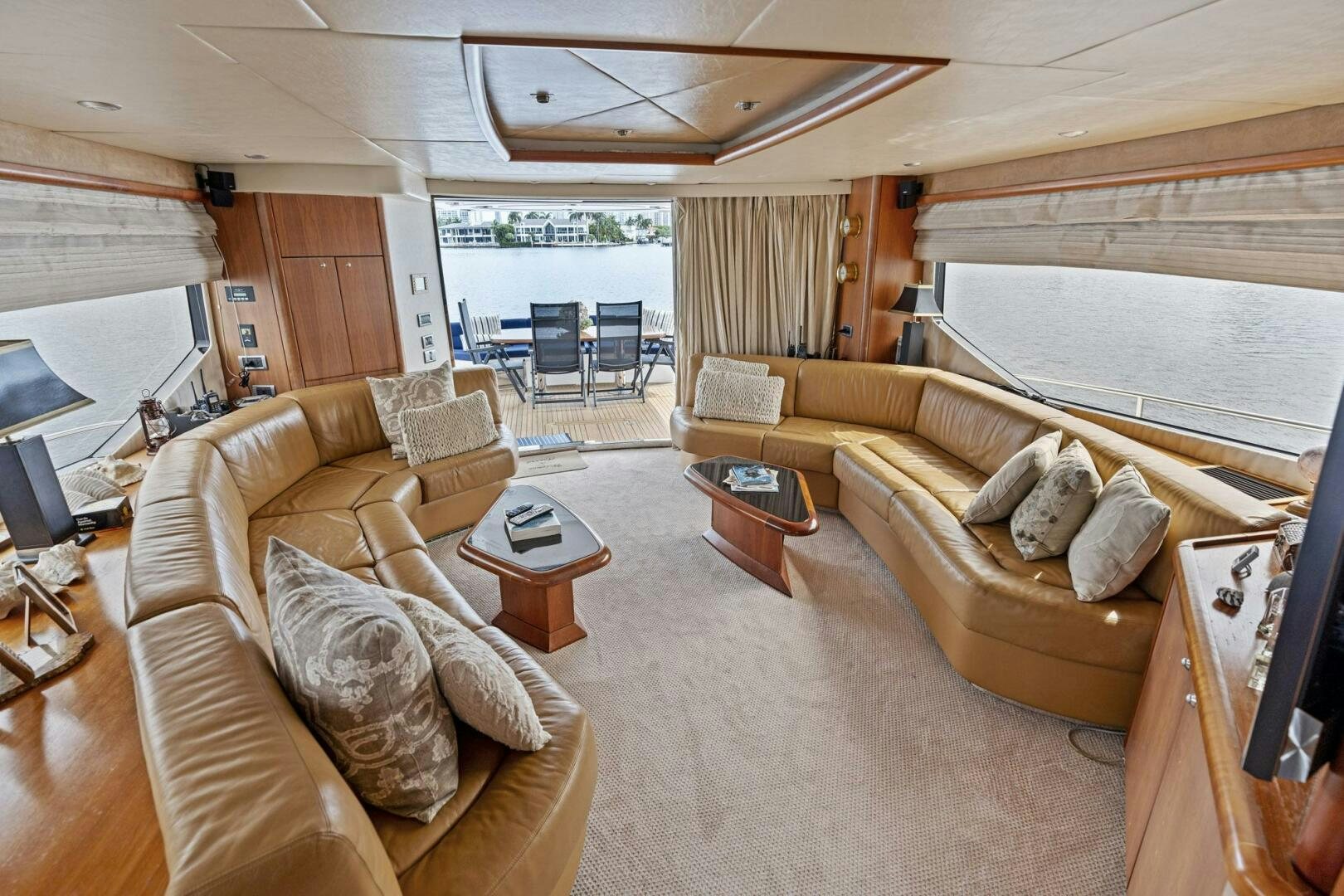 a living room with beige furniture aboard PERSISTENCE Yacht for Sale