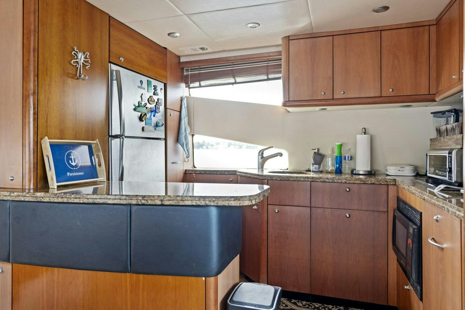 a kitchen with wooden cabinets aboard PERSISTENCE Yacht for Sale