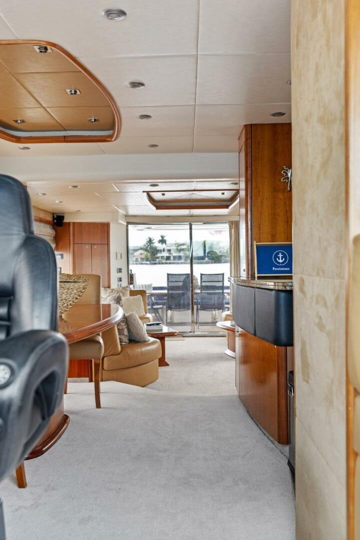 a living room with a fireplace aboard PERSISTENCE Yacht for Sale