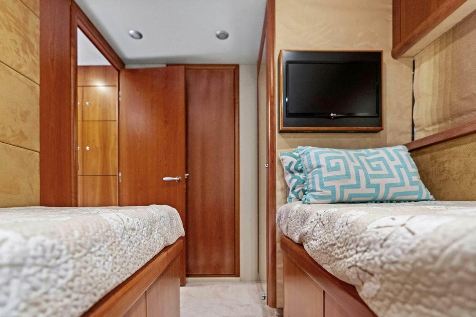 a bedroom with a bed and a television aboard PERSISTENCE Yacht for Sale