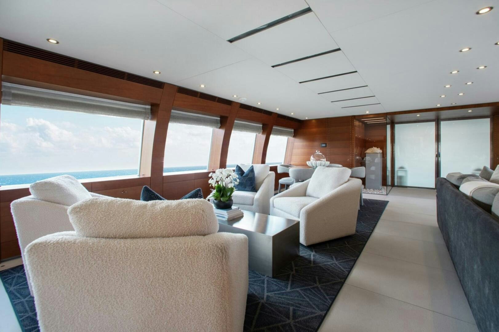a living room with white couches aboard MATRIX Yacht for Sale