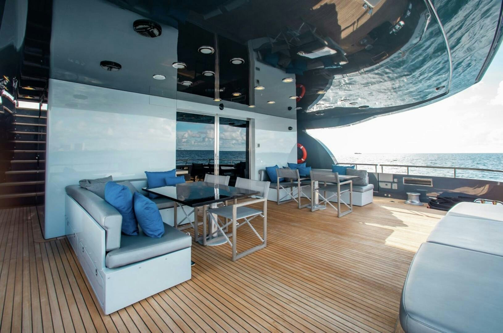 a room with a couch and a table and chairs aboard MATRIX Yacht for Sale