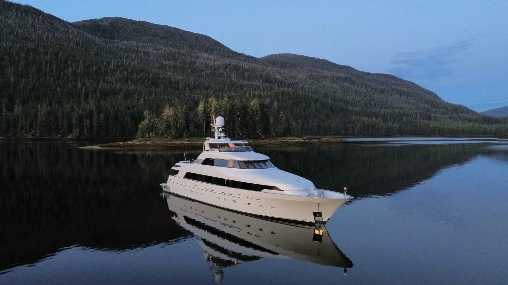 a white boat on a lake aboard RUFFIAN Yacht for Sale