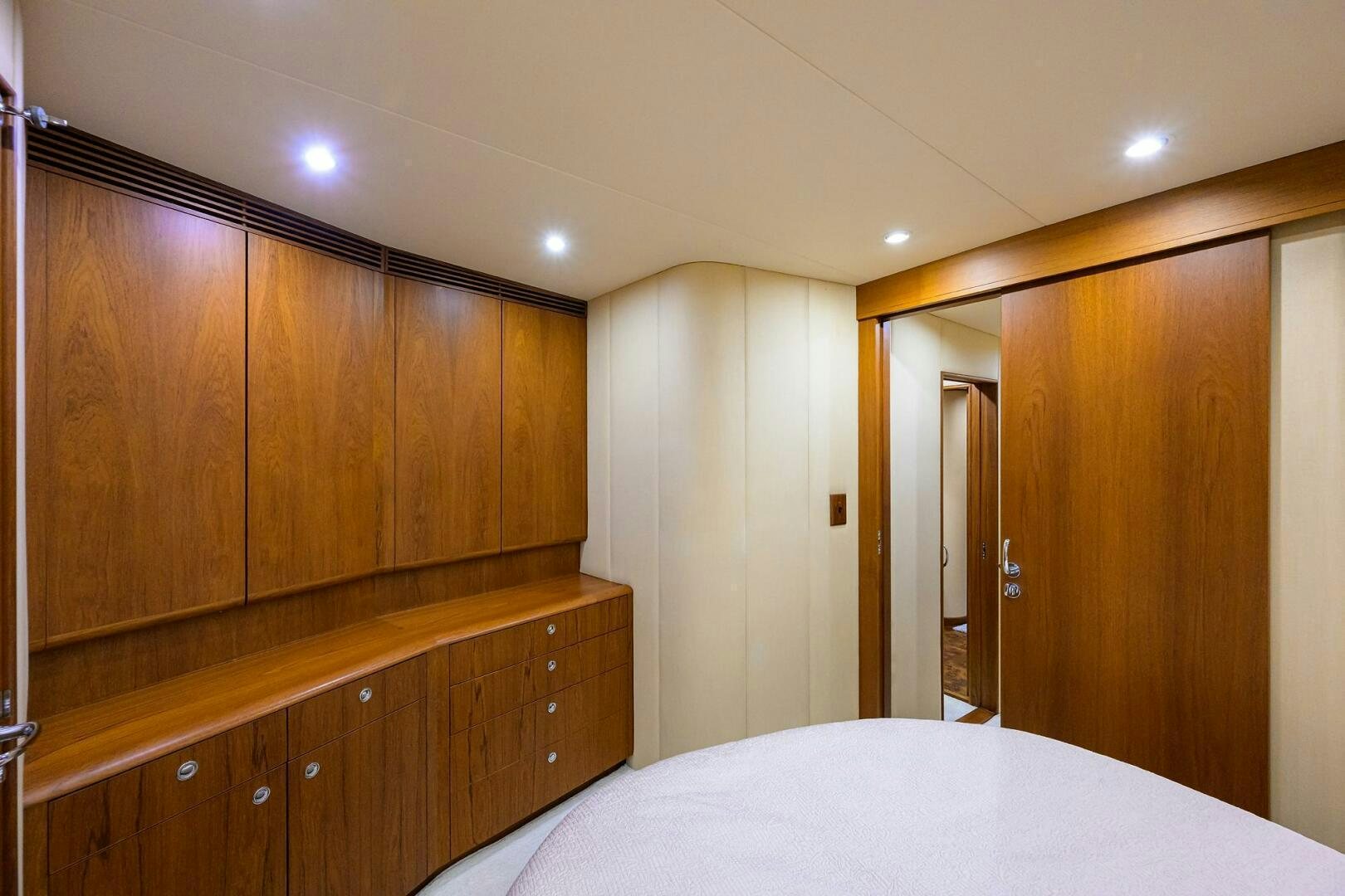 a bedroom with a large white bed aboard BUSINESS STINKS Yacht for Sale