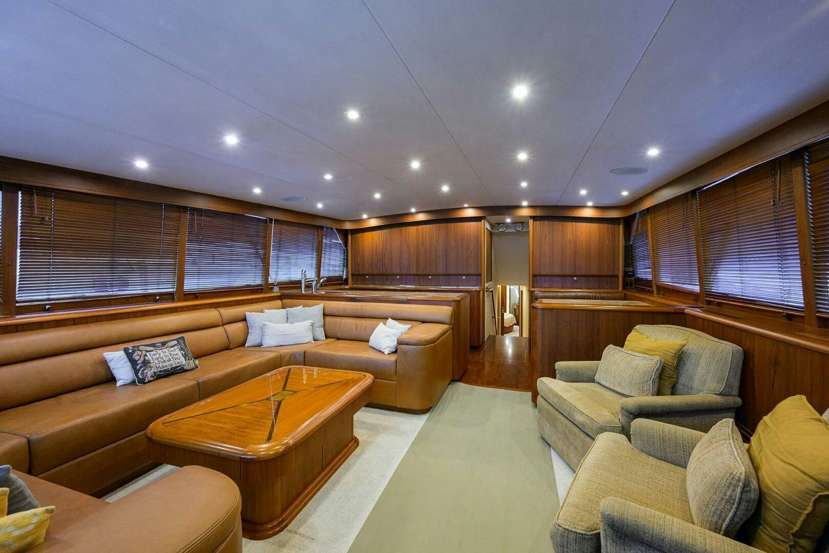 a large living room with a large window aboard BUSINESS STINKS Yacht for Sale