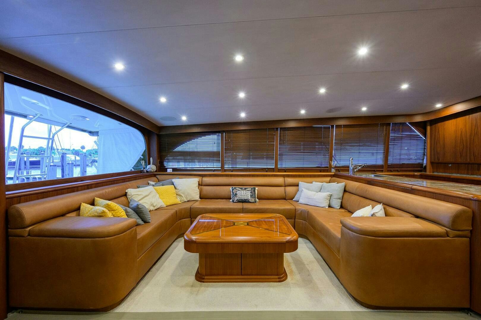 a living room with a large window aboard BUSINESS STINKS Yacht for Sale