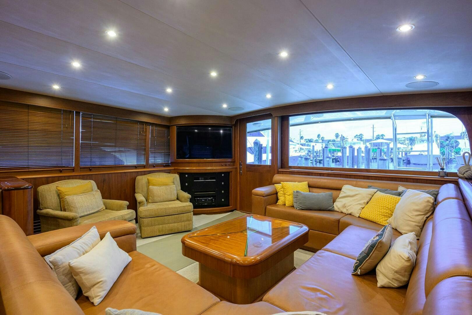 a living room with a large window aboard BUSINESS STINKS Yacht for Sale