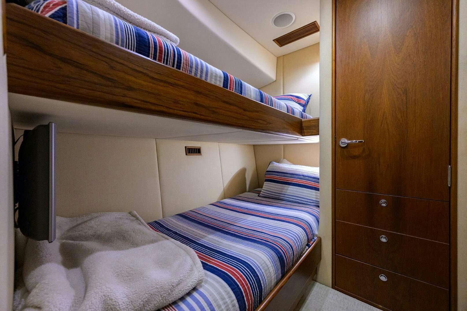 a room with a bed and a television aboard BUSINESS STINKS Yacht for Sale