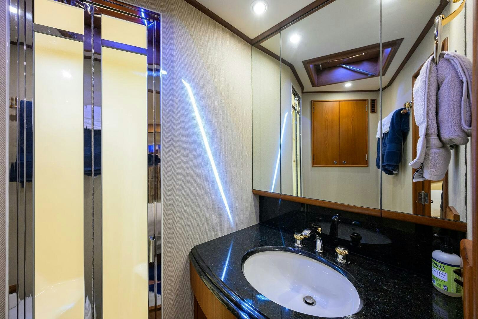 a bathroom with a sink and a shower aboard BUSINESS STINKS Yacht for Sale