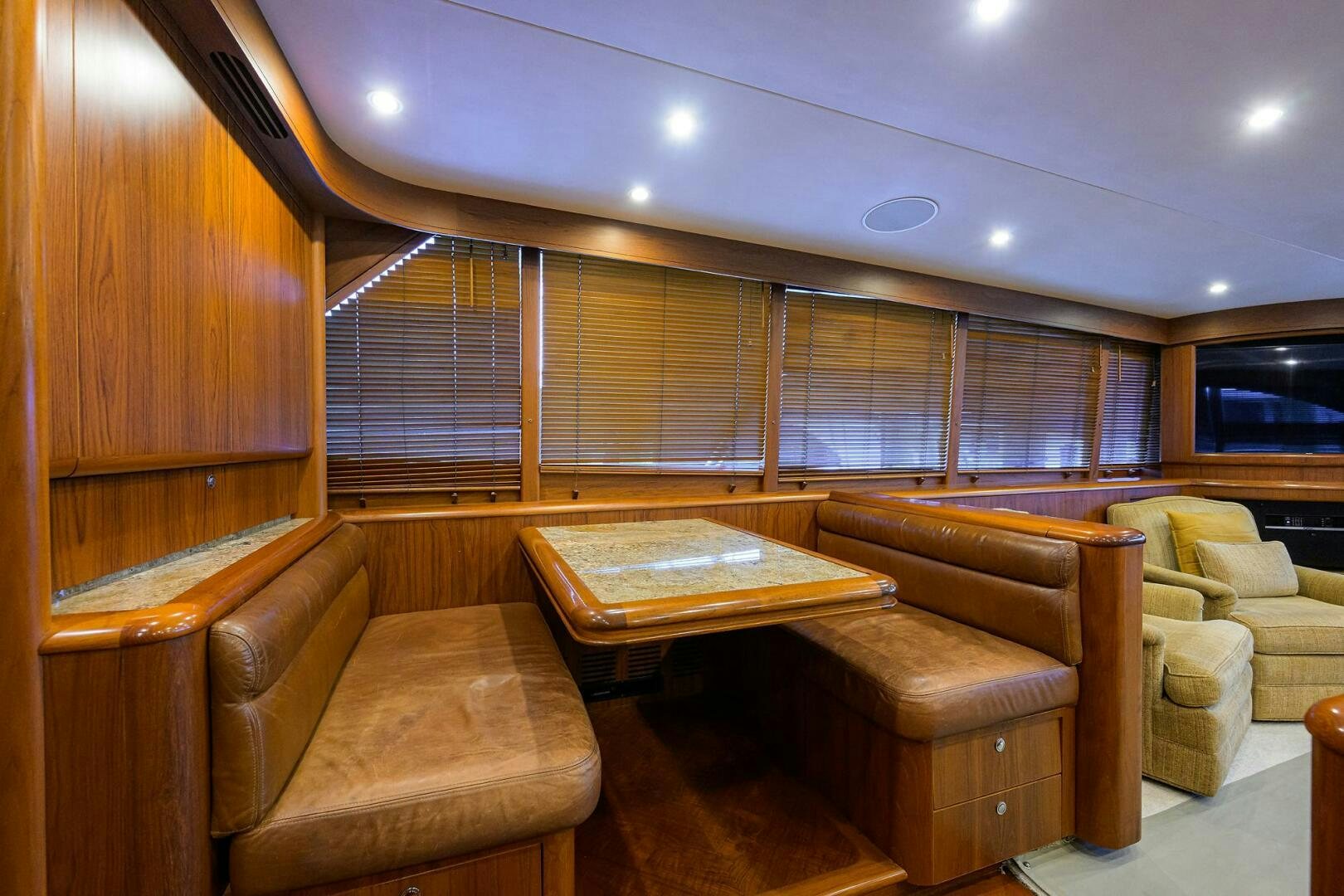 a room with couches and a coffee table aboard BUSINESS STINKS Yacht for Sale