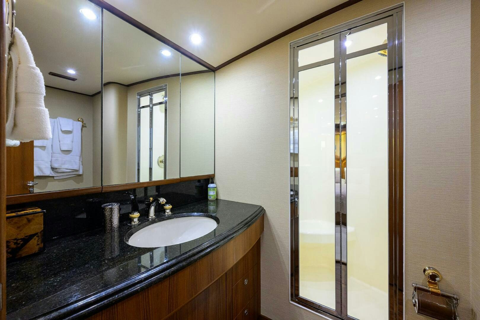 a bathroom with a large mirror aboard BUSINESS STINKS Yacht for Sale