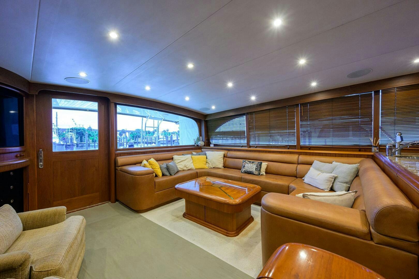 a living room with a large window aboard BUSINESS STINKS Yacht for Sale