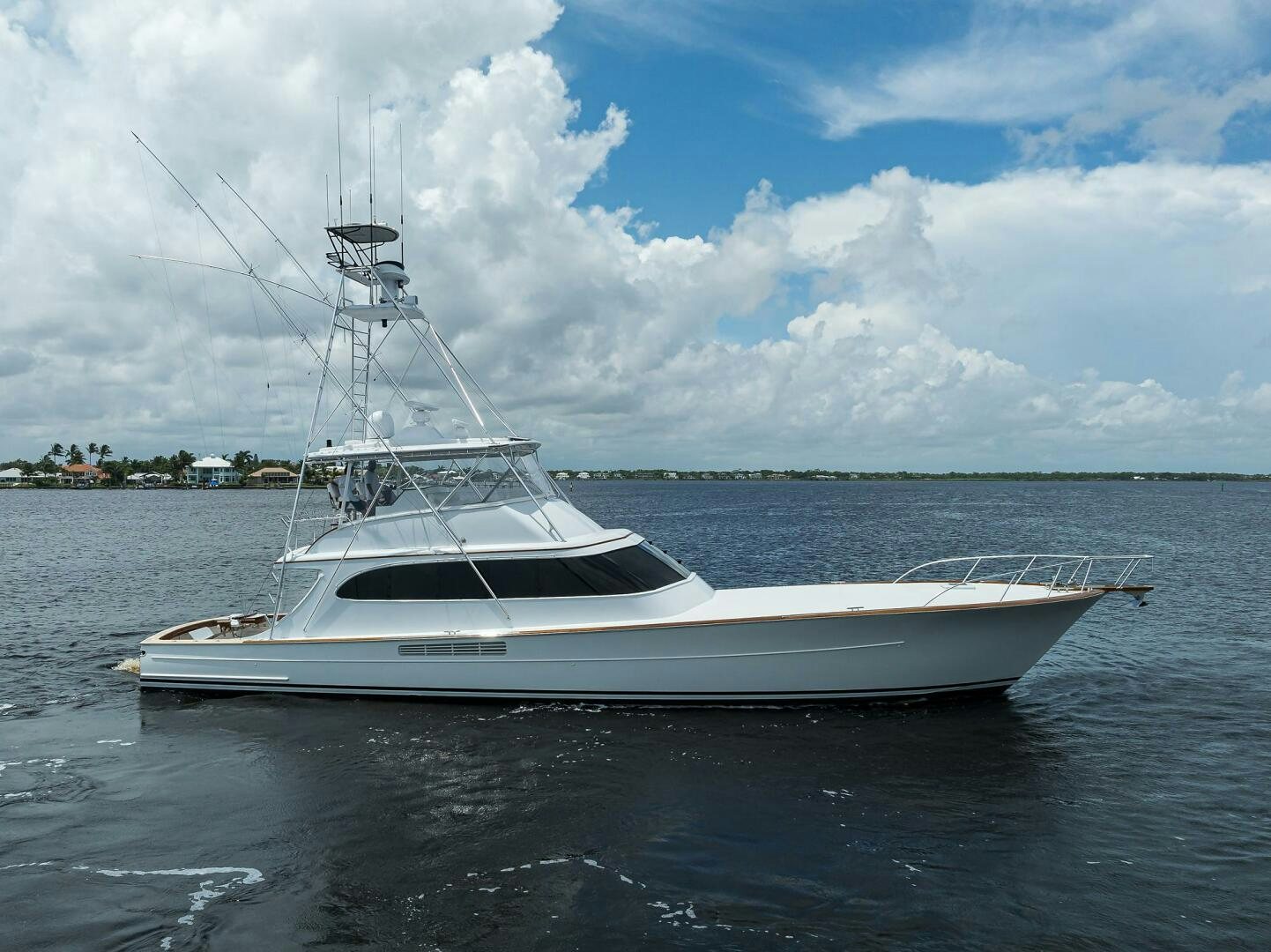 a white boat on the water aboard BUSINESS STINKS Yacht for Sale