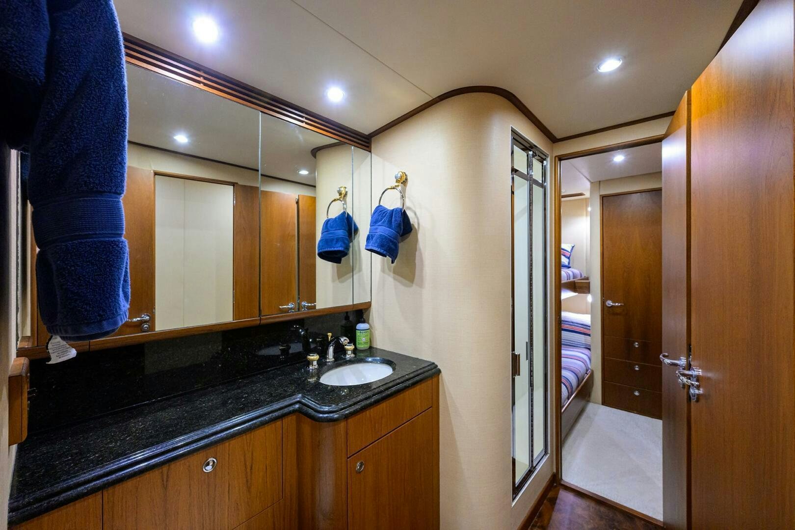 a bathroom with a sink and a mirror aboard BUSINESS STINKS Yacht for Sale